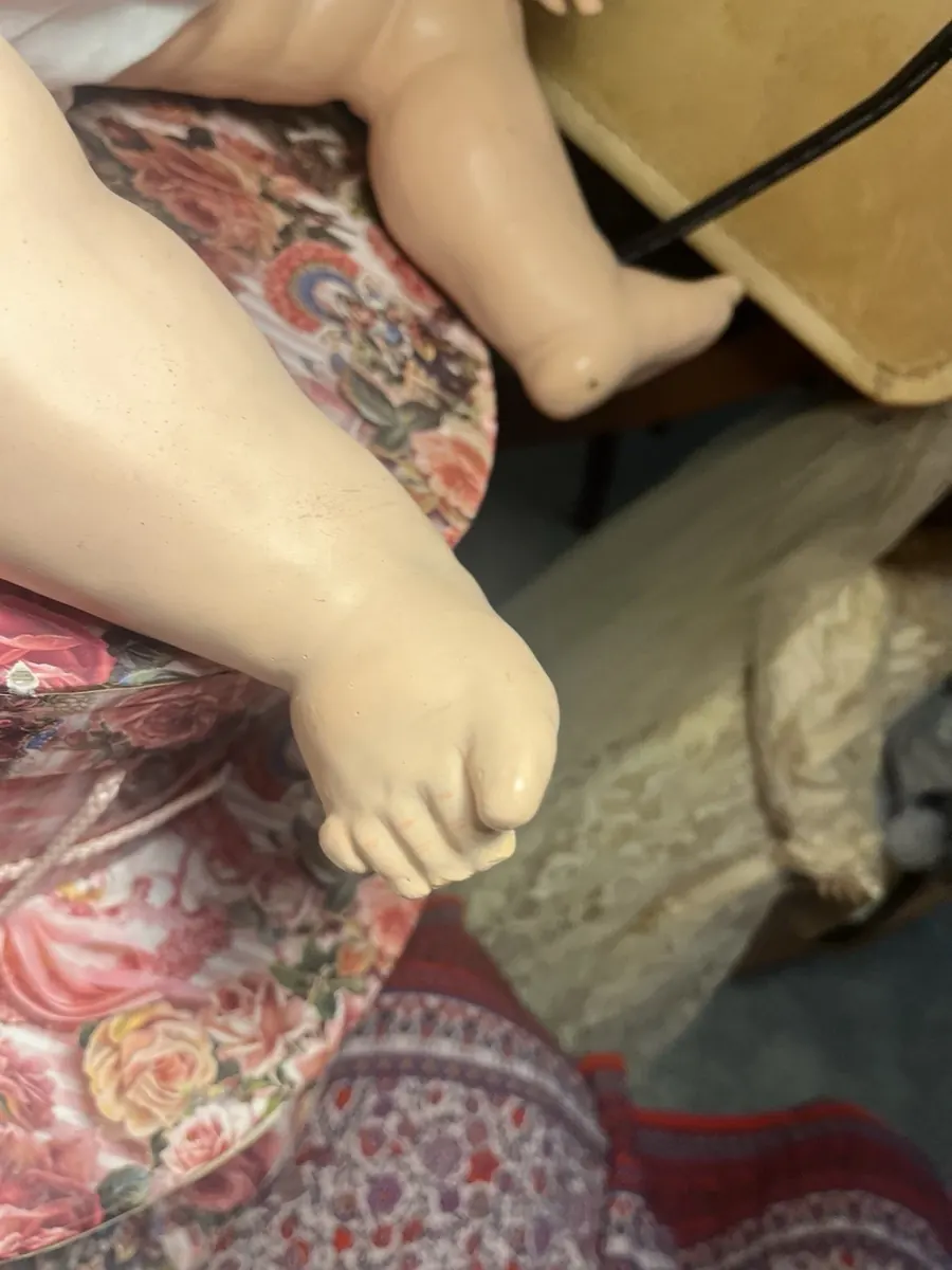 Close view of one bare foot, resting on a floral cloth.