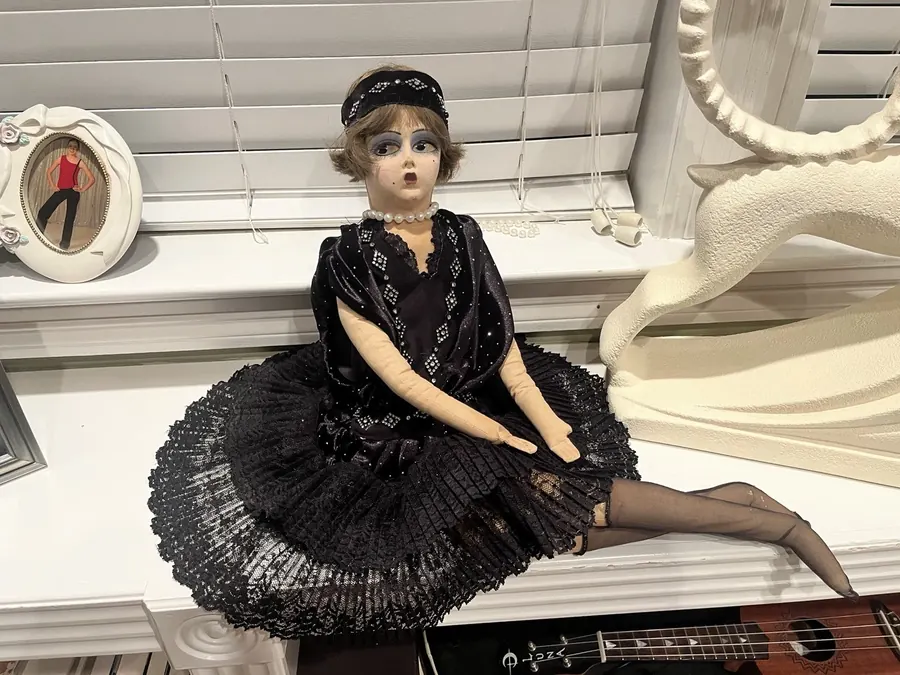 Boudoir Gerling doll seated in a black outfit, full view.
