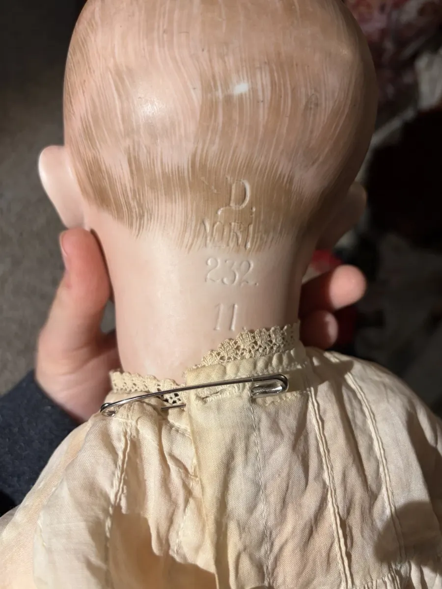The back of the head, held up to show the incised mark.