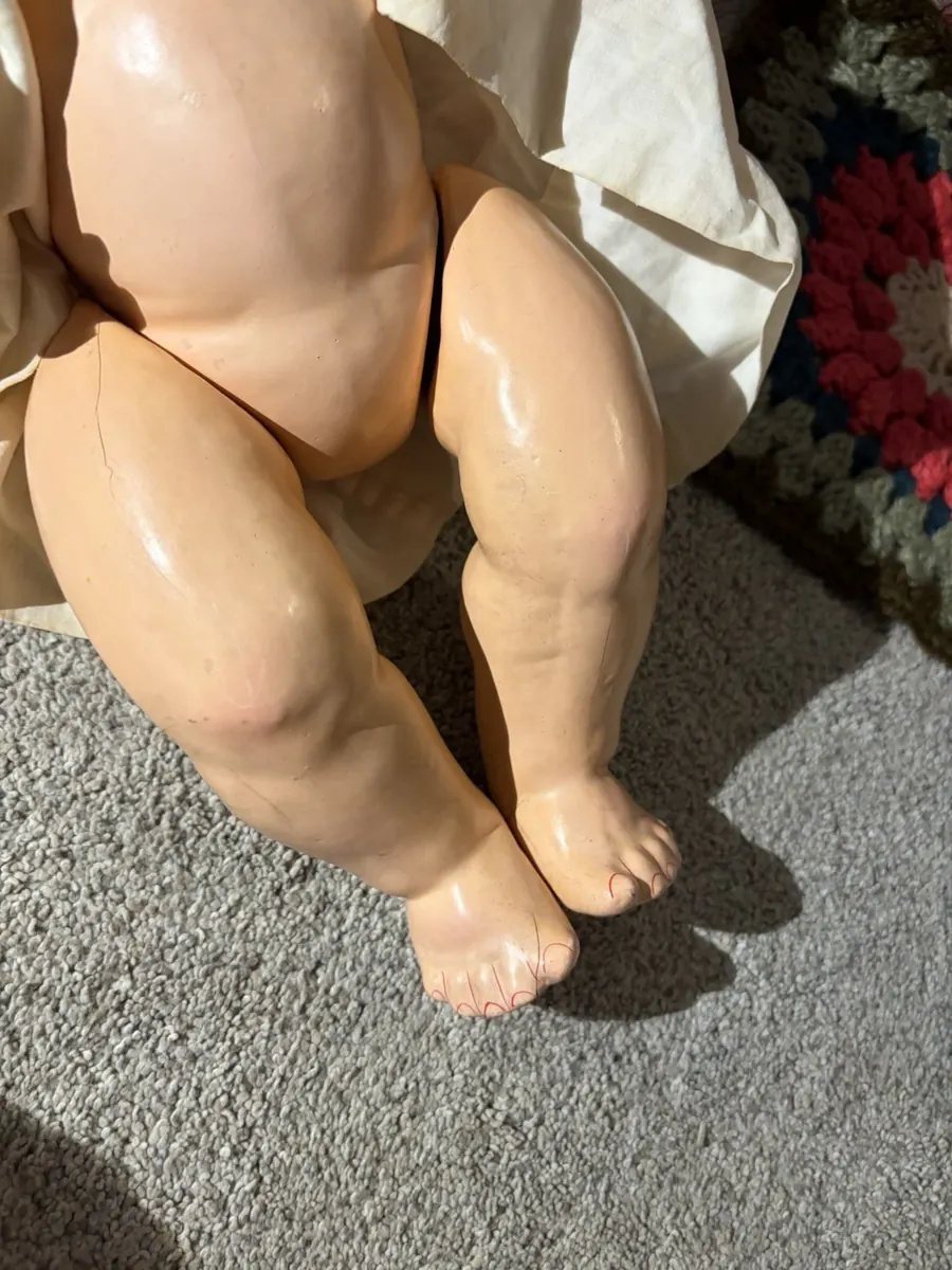 Both legs and bare feet, the gown lifted clear.