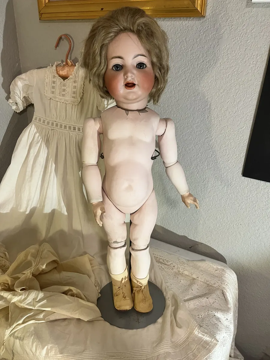 Simon and Halbig K*R 126 Toddler doll without clothing, with the dress beside it.