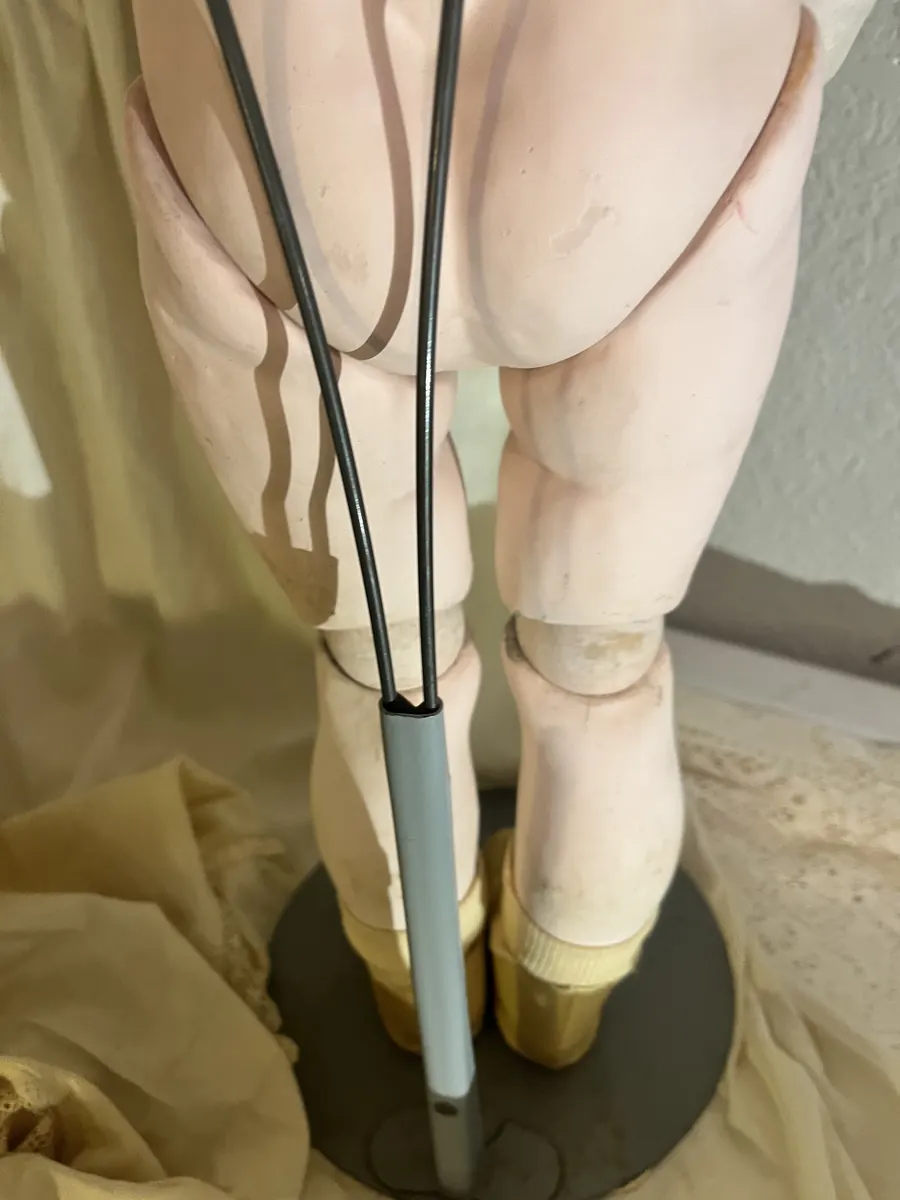 Simon and Halbig K*R 126 Toddler doll, lower legs and stand viewed from behind.